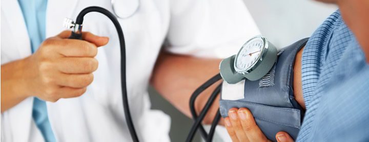 Doctor takes patient's blood pressure