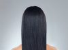 back profile image of black woman with chemically relaxed hair