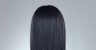 back profile image of black woman with chemically relaxed hair