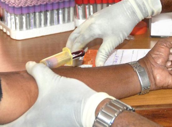 Clinical trials and importance of transparency Nurse taking blood from a man