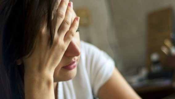 depressed woman holding head