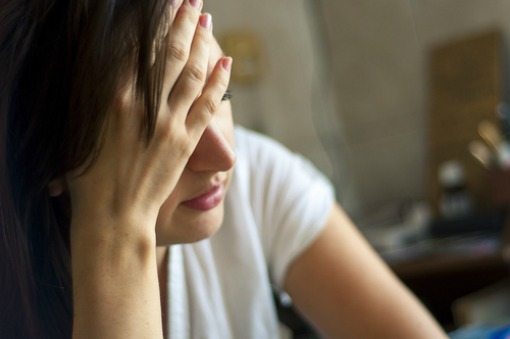 depressed woman holding head