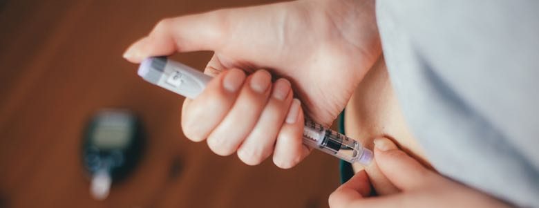 woman taking an epipen injection