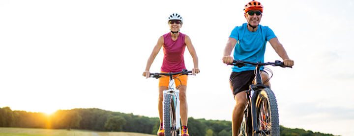 Adult couple biking together