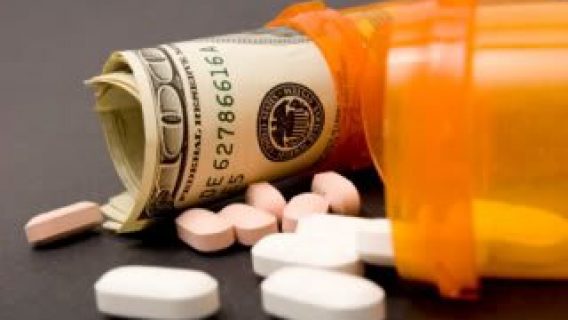 Prescription bottles holding pills and money