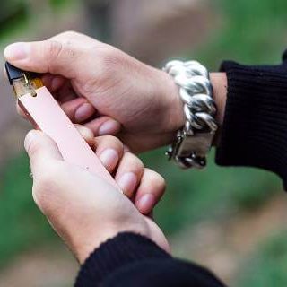 Man loading cartridge on e-cigarette