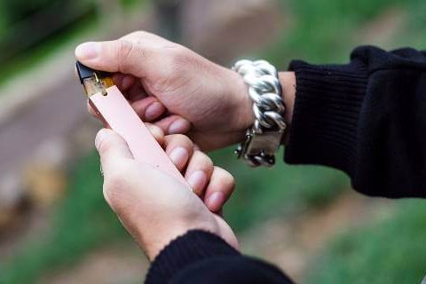 Man loading cartridge on e-cigarette