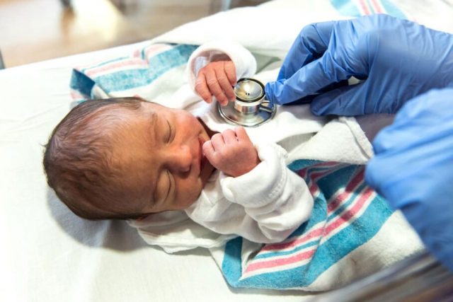 Checking a newborns heart beat