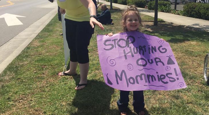 little girl holding a protest sign