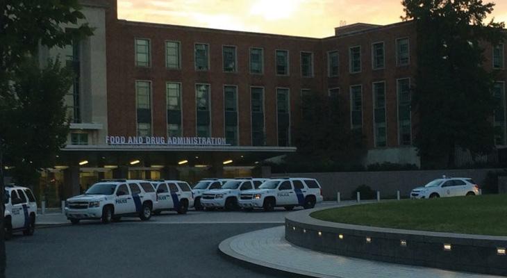 several police SUVs in front of the FDA building