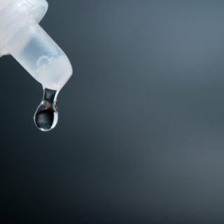 Eye drop closeup on black background