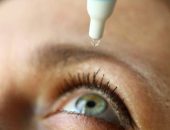 Woman putting drops in eye