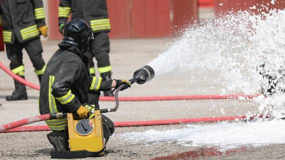 Firefighter using foam