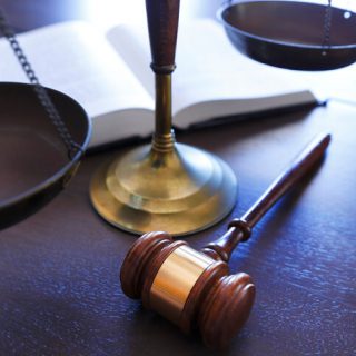 Gavel and scale on wooden desk