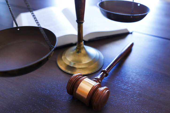 Gavel and scale on wooden desk