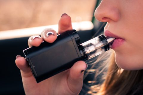 Young woman vaping