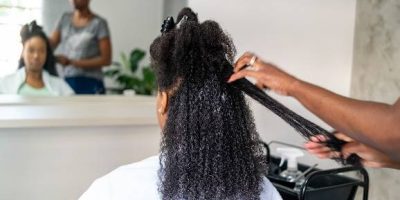 Woman having her hair straightened