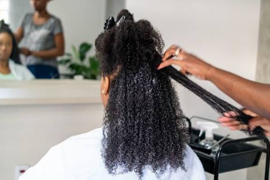 Woman having her hair straightened