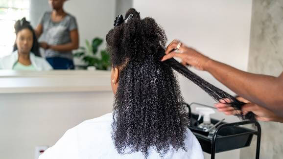 Woman having her hair straightened