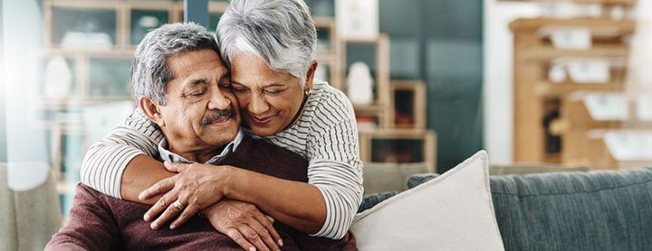 Woman lovingly embraces her husband