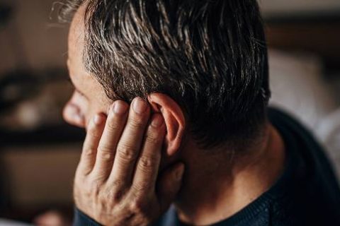 Man with hearing loss and hand to ear