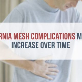 pained man standing, holding his stomach and head