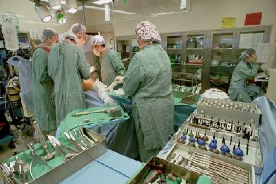 Operation room with doctors completing Hip Surgery