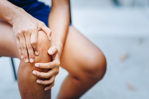 Young woman with knee pain