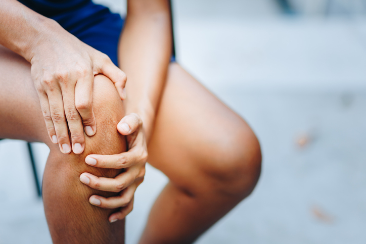Young woman with knee pain