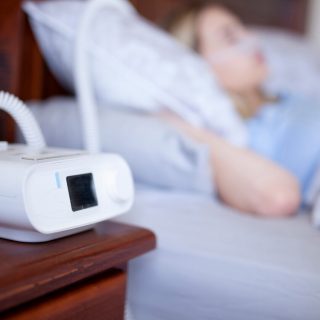 Woman sleeping and using a CPAP machine