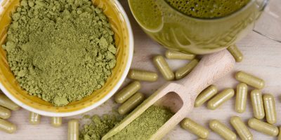 kratom capsules and powder on a table
