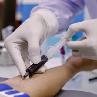 Nurse taking a patient's blood