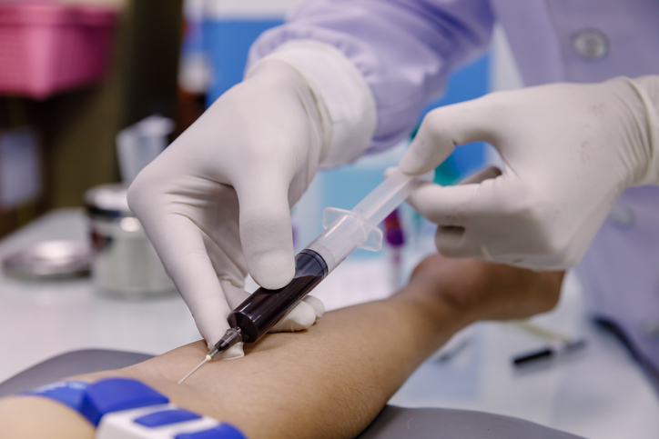 Nurse taking a patient's blood