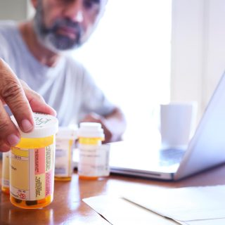 Man looking at a pill bottle