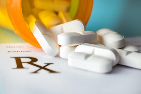 Pills spilling out of prescription bottle