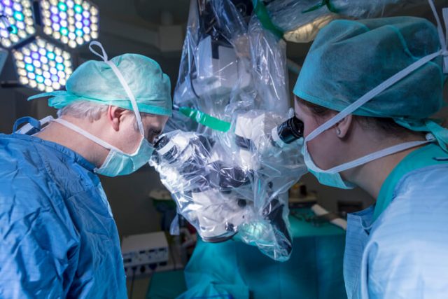 Doctors performing surgery using a robot