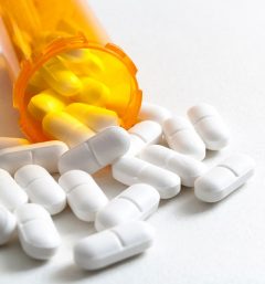 Opioids spilling out of pill bottle