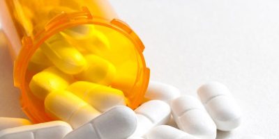 Opioids spilling out of pill bottle