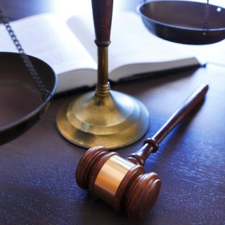 Gavel and scale on wooden desk