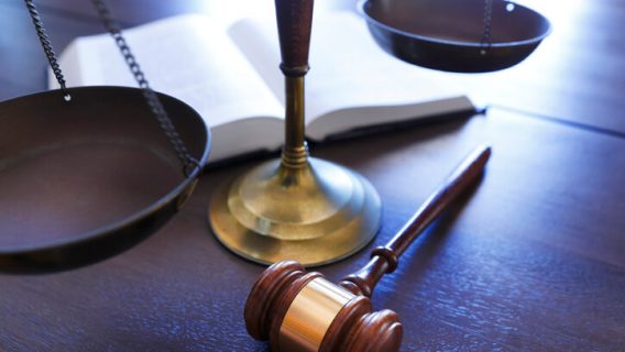 Gavel and scale on wooden desk