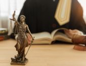 Statue of justice with judge and gavel