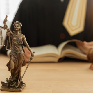 Statue of justice with judge and gavel