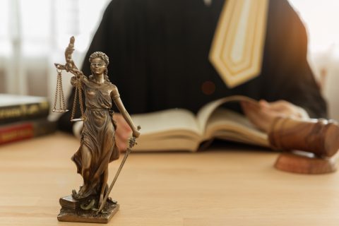 Statue of justice with judge and gavel