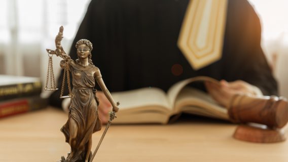 Statue of justice with judge and gavel
