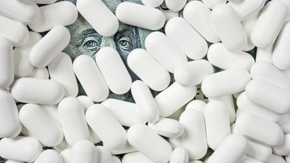 Pharmaceutical pills atop money