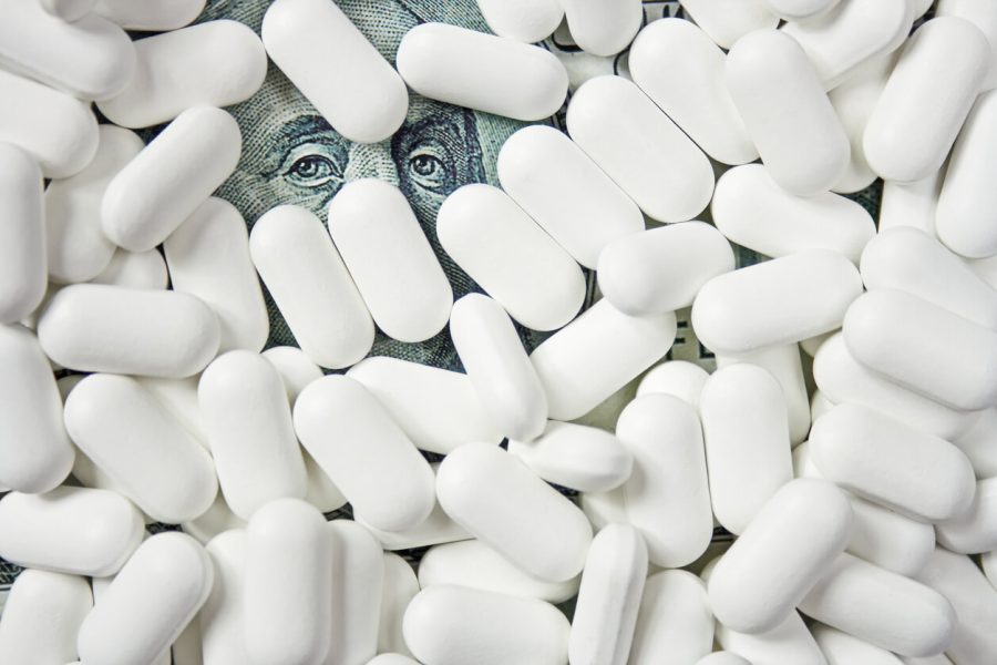 Pharmaceutical pills atop money