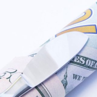 scalpel on top of money
