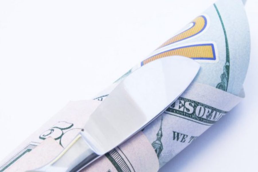 scalpel on top of money