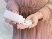 Woman pouring talcum powder