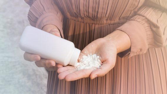 Woman pouring talcum powder